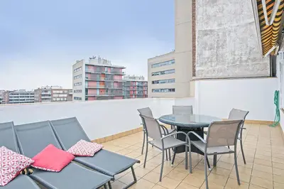 a table and chairs on a balcony with a view at Sarria Attic in Barcelona