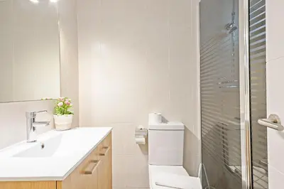 a bathroom with a toilet and a sink and a shower at Sarria Attic in Barcelona