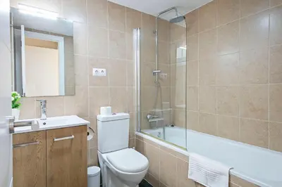 a bathroom with a toilet and a sink and a shower at Sarria Attic in Barcelona