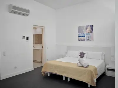 a white bedroom with a bed with a blanket at Villa in Sitges with Pool, Jacuzzi, BBQ, View, AC, 12Pax in Sitges