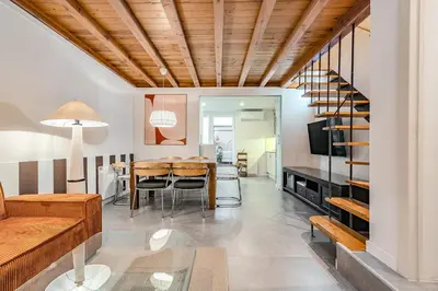 a living room with a table and a dining room at Encantador Apartamento con Terraza en Sants in Barcelona