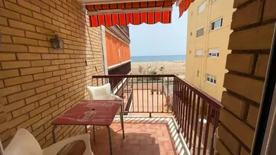 a balcony with a table and chairs and the ocean at Maresme in Canet de Mar