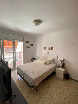 a bedroom with a bed and a flat screen tv at Maresme in Canet de Mar