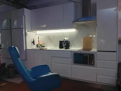 a kitchen with a blue chair in a kitchen at VERSACE 4PACK -SMART HOME- AIR CONDITIONER - GOTIC quarter- PRIVATE STUDIO- Beach 10 minutes in Barcelona