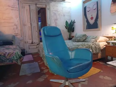 a blue chair in a room with a bed at VERSACE 4PACK -SMART HOME- AIR CONDITIONER - GOTIC quarter- PRIVATE STUDIO- Beach 10 minutes in Barcelona