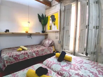a room with two beds and a couch at VERSACE 4PACK -SMART HOME- AIR CONDITIONER - GOTIC quarter- PRIVATE STUDIO- Beach 10 minutes in Barcelona