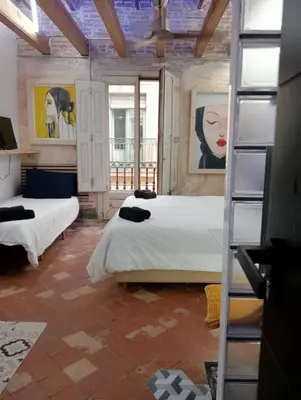 a bedroom with two beds and a window at VERSACE 4PACK -SMART HOME- AIR CONDITIONER - GOTIC quarter- PRIVATE STUDIO- Beach 10 minutes in Barcelona