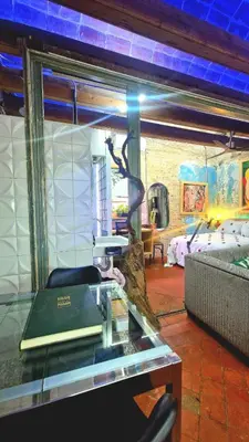 a room with a glass table with a chair in it at VERSACE 4PACK -SMART HOME- AIR CONDITIONER - GOTIC quarter- PRIVATE STUDIO- Beach 10 minutes in Barcelona
