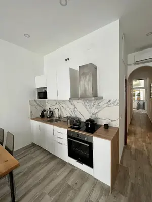 a kitchen with white cabinets and a stove top oven at 3 min to metro Center 15 min by metro Beach 15min in Santa Coloma de Gramanet