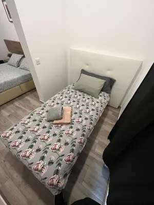a bed in a small room with apillow at 3 min to metro Center 15 min by metro Beach 15min in Santa Coloma de Gramanet