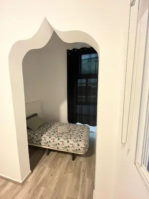 a bedroom with a bed in a room with an archway at 3 min to metro Center 15 min by metro Beach 15min in Santa Coloma de Gramanet