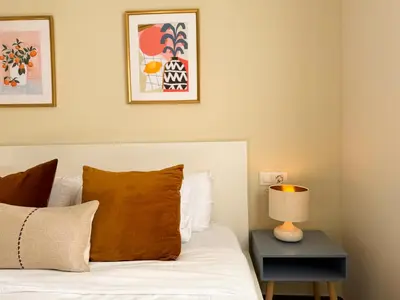 a bedroom with a bed with a lamp on a table at Boutique Remei in Barcelona