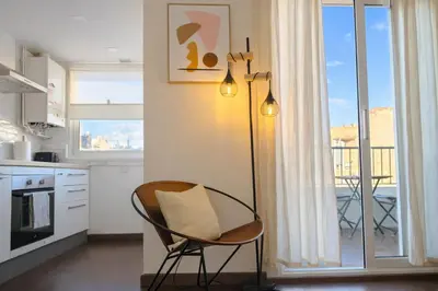 a chair in a kitchen with a view of a balcony at Boutique Remei in Barcelona
