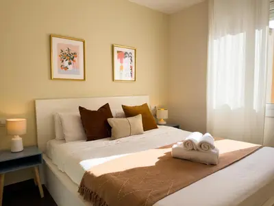 a bedroom with a large bed with two towels on it at Boutique Remei in Barcelona