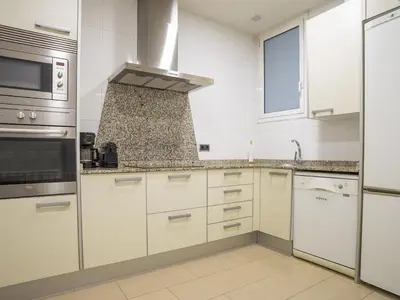 a kitchen with white cabinets and a stove top oven at Apartamento en el centro de Barcelona! in Barcelona