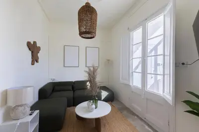 a living room with a couch and a table at ATA Five Rooms Mid term Rental in Barcelona