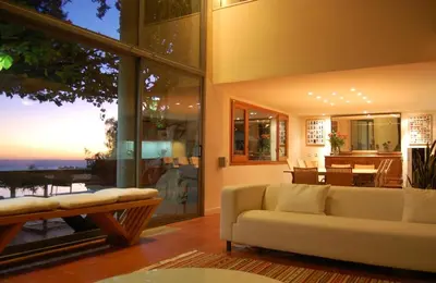 a living room with a white couch and a table at Casa Roca Lujo mediterráneo con piscina infinity in Sitges