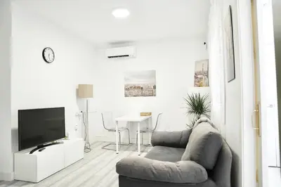 a living room with a couch and a tv at \u6ee8\u6d77\u522b\u5885 in Premia de Dalt