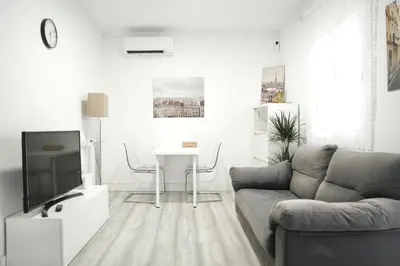 a living room with a couch and a tv at \u6ee8\u6d77\u522b\u5885 in Premia de Dalt