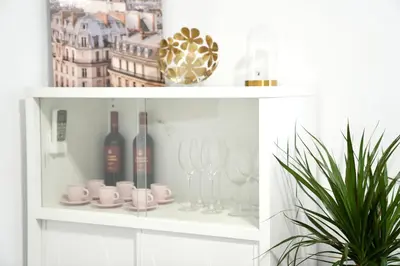 a white shelf with wine glasses and a plant at \u6ee8\u6d77\u522b\u5885 in Premia de Dalt