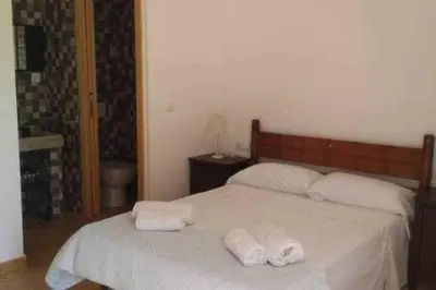 a bedroom with two towels on a bed at Casa de pueblo con encanto in Arbós