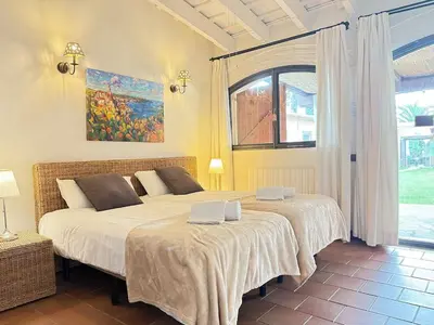 a bedroom with two beds and a window at Masia Notari Casabona in Vilanova i la Geltrú