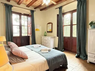 a bedroom with a bed with two towels on it at Masia Notari Casabona in Vilanova i la Geltrú