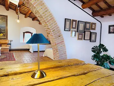 a room with a table with a lamp on it at Masia Notari Casabona in Vilanova i la Geltrú