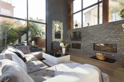 a living room with a couch and a fireplace at Espai Oliveres Barcelona Villa con piscina in Papiol