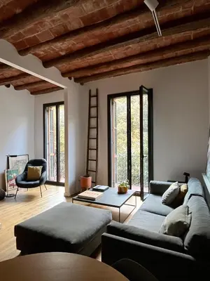 a living room with a couch and a chair at Spacious and cozy apartment in Barcelona