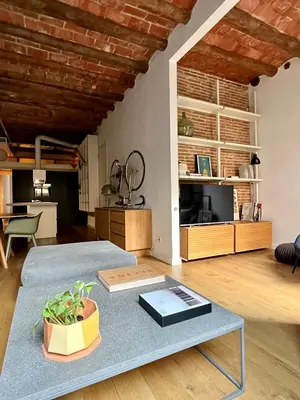 a living room with a couch and a table at Spacious and cozy apartment in Barcelona