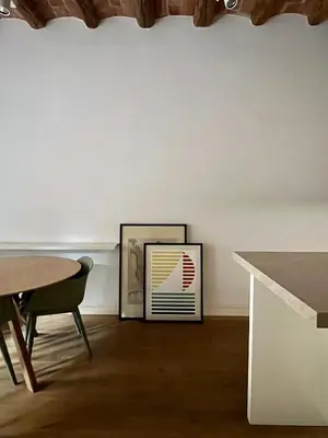 a room with a table and a picture on a wall at Spacious and cozy apartment in Barcelona