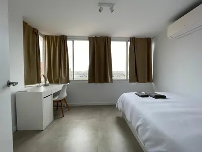 a bedroom with a bed and a desk and window at NEW 2-bedroom 2-bath, 5 min walk Metro L1-FIRA BCN in Hospitalet de Llobregat