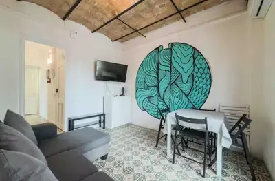 a living room with a table and a couch at Apartment in BCN 2-1 in Hospitalet de Llobregat