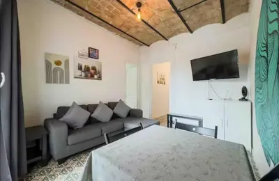 a living room with a couch and a tv at Apartment in BCN 2-1 in Hospitalet de Llobregat
