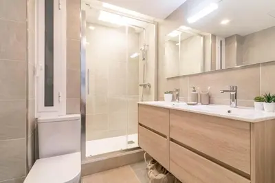 a bathroom with a toilet and a sink and a shower at MODERN PENTHOUSE WITH TERRACE ON GRAN VIA DE CARLES III Andorra in Barcelona