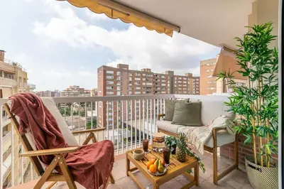a balcony with a couch and a table with fruits at MODERN PENTHOUSE WITH TERRACE ON GRAN VIA DE CARLES III Andorra in Barcelona