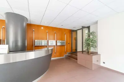 a waiting room with a potted plant in a building at MODERN PENTHOUSE WITH TERRACE ON GRAN VIA DE CARLES III Andorra in Barcelona