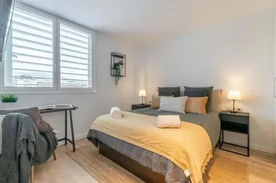 a bedroom with a bed and a desk and a window at MODERN PENTHOUSE WITH TERRACE ON GRAN VIA DE CARLES III Andorra in Barcelona