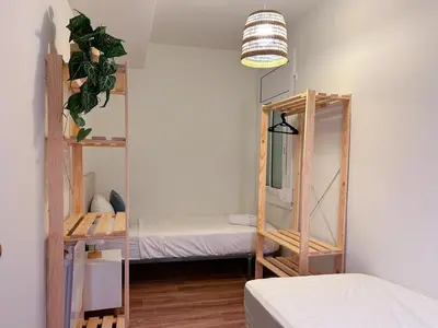 a room with two bunk beds and a mirror at Apt Matisse in Vilanova i la Geltrú