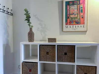 a white shelf with a vase on top of it at Apt Matisse in Vilanova i la Geltrú