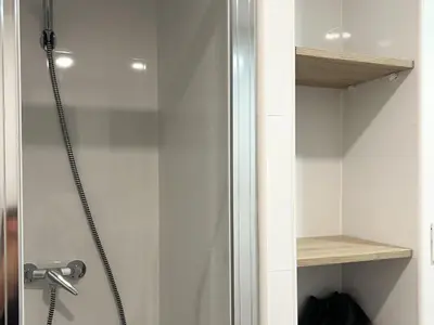 a shower in a bathroom with a glass door at Apt Matisse in Vilanova i la Geltrú