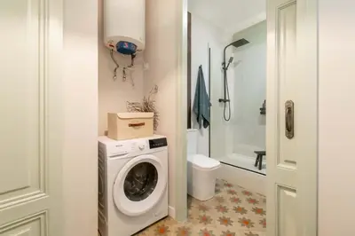 a bathroom with a washing machine and a toilet at BOLIVIA. NEWLY RENOVATED FULL APARTMENT WITH BRIGHT TERRACE in Barcelona