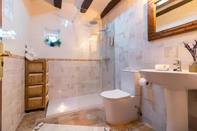a bathroom with a toilet and a sink and a shower at Masía con encanto para parar y desconectar in Castellví de la Marca