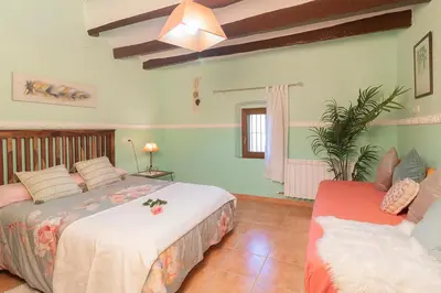 a bedroom with two beds in a room at Masía con encanto para parar y desconectar in Castellví de la Marca