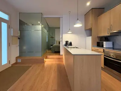a kitchen with a refrigerator and a counter top at Stay Unique Sarrià–Sant Gervasi terraza privada in Barcelona