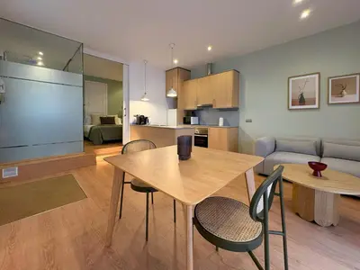 a kitchen and living room with a table and chairs at Stay Unique Sarrià–Sant Gervasi terraza privada in Barcelona