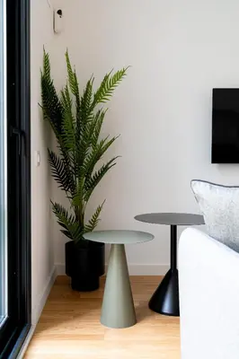 a living room with a table and a plant at Stay U-nique Apartments Barcelona Albeniz in El Arrabal