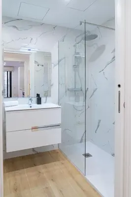a white bathroom with a shower and a sink at Stay U-nique Apartments Barcelona Albeniz in El Arrabal