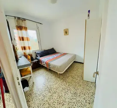 a bedroom with a bed and a desk and a window at Barcelona stay in Hospitalet de Llobregat